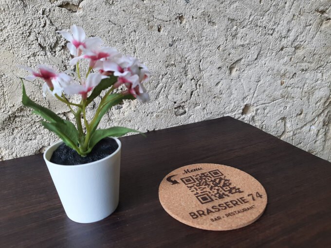 Drink's coaster with QR code on a cafe table