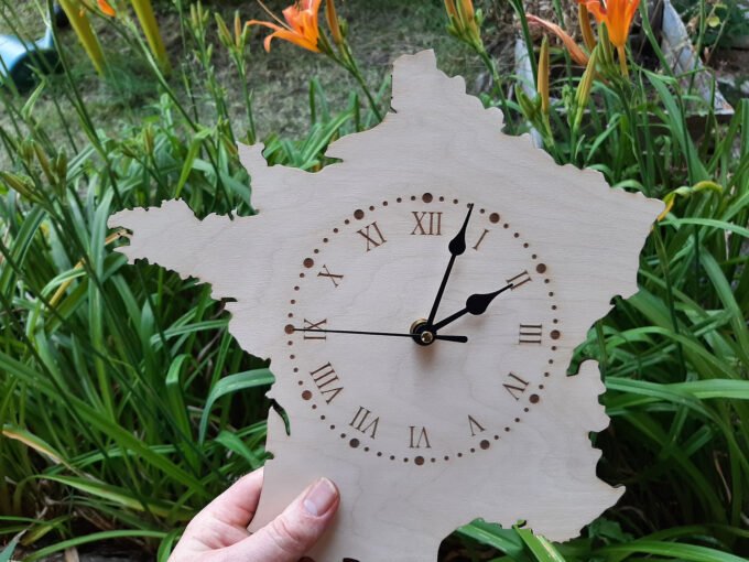 France country shaped clock held in hand