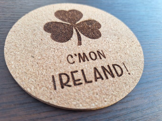 Drink coaster with C'mon Ireland and a shamrock engraved on it