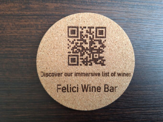 Drink coaster with QR code engraved on it