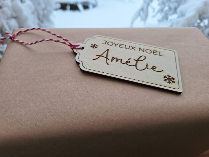 Personalised gift tag lying on gift box