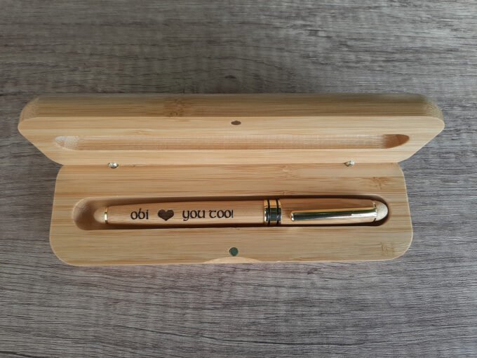 Bamboo pen box containing a pen