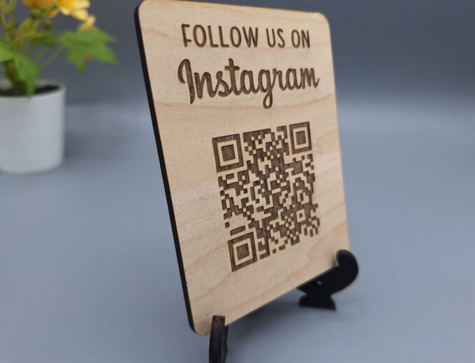 Close up view of wooden QR code sign with link to Instagram social media