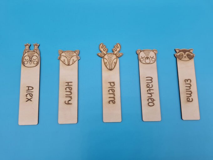 Bookmarks for children with different animal designs. Children's names are engraved onto the wooden bookmark