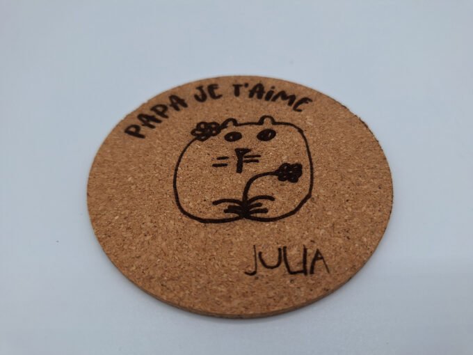 Drink coaster made from cork with laser engraved art drawing and text